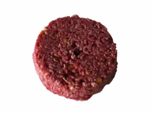 A round red block of rat poison mixed with grains
